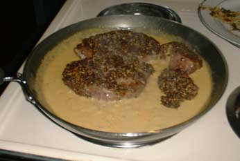 Steak simmering in the sauce